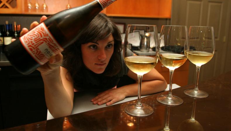 Image of a woman pouring wine at the Wine Loft at slate street cafe